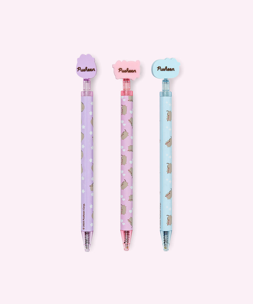 Back view of the three gel pens with decorative Pusheen tops. The back of the silicone toppers have the Pusheen the Cat logo in brown.