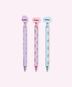 Back view of the three gel pens with decorative Pusheen tops. The back of the silicone toppers have the Pusheen the Cat logo in brown.