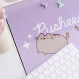 Close-up of the slightly reflective plastic material that encases the Pusheen design on the desk mat. 