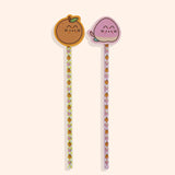 Pencils and erasers in the Pusheen Fruits 2-Pencil Set. The full-length pencils include and all over print of Pusheen as peaches and oranges on orange and pink checkered pencils. Atop the pencils are the included erasers or Pusheen taking the form of an orange and a pink and yellow peach.