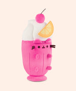 Right quarter view of the medium sized plush. The felt orange slice sits off the middle and top portion of the plush. Pusheen's ears and four paws extend off the body of the drink container portion of the plush. 