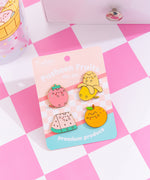 Pusheen Fruits Pin Set and backer card. The backer card has a pink checkered print, solid pink and blue backgrounds, and features the phrase "premium produce" at the bottom in white.
