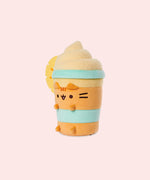 Left quarter view of the Pineapple Float Plush. The drink-inspired plush has a fuzzy whipped topping in a swirl pattern.