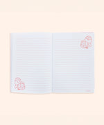Interior view of the plush notebook. The inside cover features a pink checkered print with bananas and Pusheen Bananas in a scattered pattern.