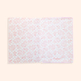 Interior view of the plush notebook. The inside cover features a pink checkered print with bananas and Pusheen Bananas in a scattered pattern.