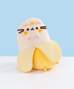 Front view of the Banana Plush. Pusheen the Cat's classic facial features are embroidered in dark brown while her blush and three head stripes are embroidered in a golden yellow thread.