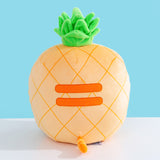 Back view of the Pineapple Squisheen Plush. The darker yellow grid pattern extends fully around the plush. On the back of the plush are embroidered darker yellow stripes to mimic Pusheen’s classic back stripes. Extending off the bottom back of the Pusheen is a yellow and darker yellow striped tail. 