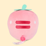 Back view of the Pusheen Fruits Strawberry Squisheen Plush. On the back of the light pink squisheen is Pusheen’s signature back stripes duo embroidered in dark pink. Under the stripes is Pusheen’s striped tail in alternating pink colors. Coming off the top of the plush are green felt leaves and a stem. 