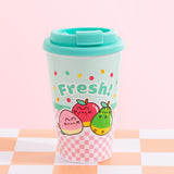 A pink and mint travel mug with a mint green lide. The mug has a pink checkered print on the bottom and mint on top. The front graphic of the Travel Mug includes Pusheen as various fruits characters including a winking pink peach, a shiny red apple, and a relaxed green pear. The phrase “Fresh!” is above the fruit graphics in mint green and is surrounded by orange, red, and green confetti. 