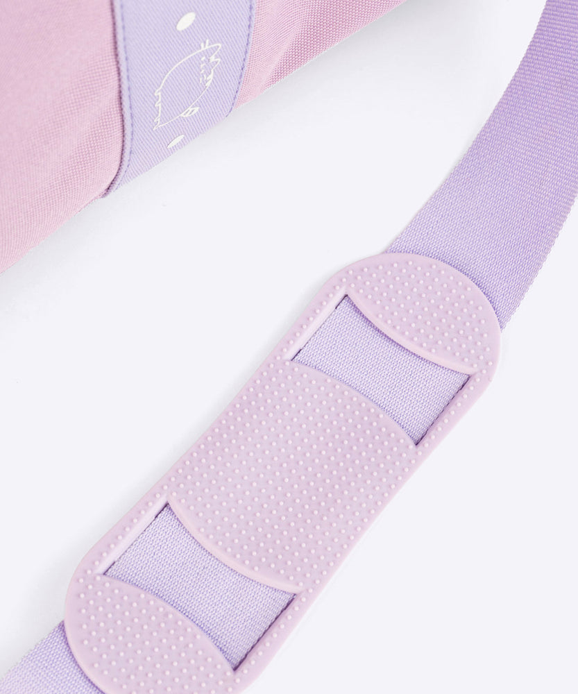 Close-up of the shoulder guard on the adjustable, removable strap attached to the purple duffle bag. 