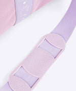 Close-up of the shoulder guard on the adjustable, removable strap attached to the purple duffle bag. 