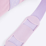Close-up of the shoulder guard on the adjustable, removable strap attached to the purple duffle bag. 