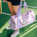Model holds the top straps on the purple duffle bag. A mesh pocket is located on one side of the bag. Printed on the front of the bag is a graphic of Pusheen the Cat with the phrase "so lazy, can't move."