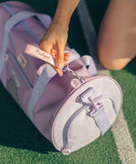 Model holds zipper pull on the Pusheen Gym Bag. The separate zippered shoe compartment can be seen. 