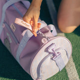 Model holds zipper pull on the Pusheen Gym Bag. The separate zippered shoe compartment can be seen. 