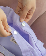 Close-up view of the magnetic button closure on the large purple tote bag.