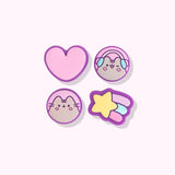 Close-up of the Nintendo Switch Pusheen thumb grip caps. From left to right and top to bottom, the grip caps featured are a pink heart with purple outline, a winking Pusheen wearing pink and blue headphones, a blushing Pusheen, and a yellow shooting star with purple, blue, and pink streaks.
