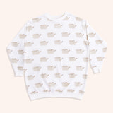 Front view of the Pusheen Loungewear Top. The cream-colored top is longer than a standard top and has long-sleeves. The top includes an all over print of Pusheen the Cat smiling. 