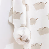 Close-up view of the interior of the tunic top. The all over print Pusheen top has a soft cream-colored interior lining. 