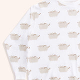 Close-up view of the Pusheen Loungewear Top’s all over print. The graphics of Pusheen the Cat show her grey standing body and leggings accented with brown features: tail stripes, back stripes, head stripes, eyes, mouth, and whiskers. 