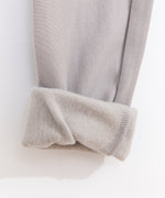 Close-up view of the interior of the leggings. The taupe bottoms have a soft taupe-colored interior lining. 