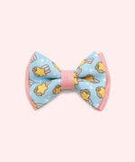Pusheen Pet Collar Bows 2-pack attached to its packaging card. The pink and purple paper card has the Pusheen Logo and cat graphic. 