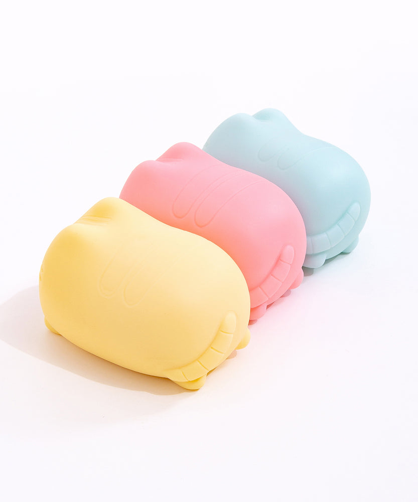 Side and back view of the Pusheen Surprise Squishy Toy Assormtnet. Pusheen's striped tail is engraved at the back of the toy.