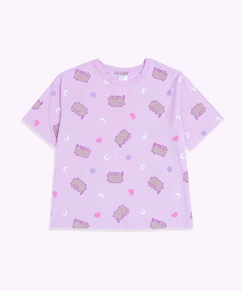 Pusheen Twilight Pajama Top lies on a flat surface. Pusheen the Cat has a grey body and is outlined in light purple and has light purple features.