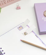 Close-up of the included small rectangular sticky notes. One of side features a graphic of Pusheen the Cat while the rest of the sticky is blank for notating purposes. 