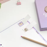 Close-up of the included small rectangular sticky notes. One of side features a graphic of Pusheen the Cat while the rest of the sticky is blank for notating purposes. 