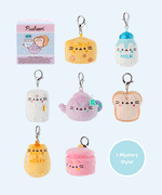 Pusheen the Cat has taken the form of seven miniature kitchen-inspired plushes. At the top left is the packaging box for the Pusheen’s Kitchen surprise plush. From left to right and top to bottom, the surprise plush are a cheese wedge, white milk jug, rectangular refrigerator, purple tea pot, white bead slice, honey jar, and a cooking pot. The bottom right corner has a circle with the words “1 Mystery Design” indicating eight possible miniature plush keychains are available. 