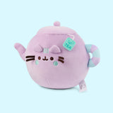 Side quarter view of the Teapot Squisheen. Pusheen's facial features are embroidered on the front of the plush and her blush and three stripes in between her ears are embroidered in a light mint green color.