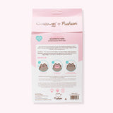 Back view of the Pusheen Sheet Mask 3-Pack Packaging. The ingredients and how to use the product is printed on the back and includes Pusheen graphics demonstrating how to use the product.