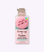 Front view of the Pusheen Strawberry Macaron Lip Balm. The circular component has Pusheen's ears, head stripes, eyes, mouth and whiskers printed in brown and pink on the front.