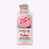 Macaron Lip Balm in its packaging. Printed on the front of the packaging is The Creme Shop and Pusheen logos as well as a few product ingredients including hyaluronic acid and murumuru.