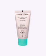 Back view of the hand cream tube. The bottle has a product description telling the user that the cream with help nourish and moisturize their dry skin.