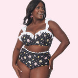 Model shows off the Pusheen Tropical Fruit Swimsuit. The black swim set features an all over print of Pusheen and Stormy with polka dots.