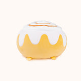 A back view of the Cinnamon Bun Squisheen, with the rim of the frosting going around the back. The plush does not have a tail. Pusheen's feet peek out from the bottom.