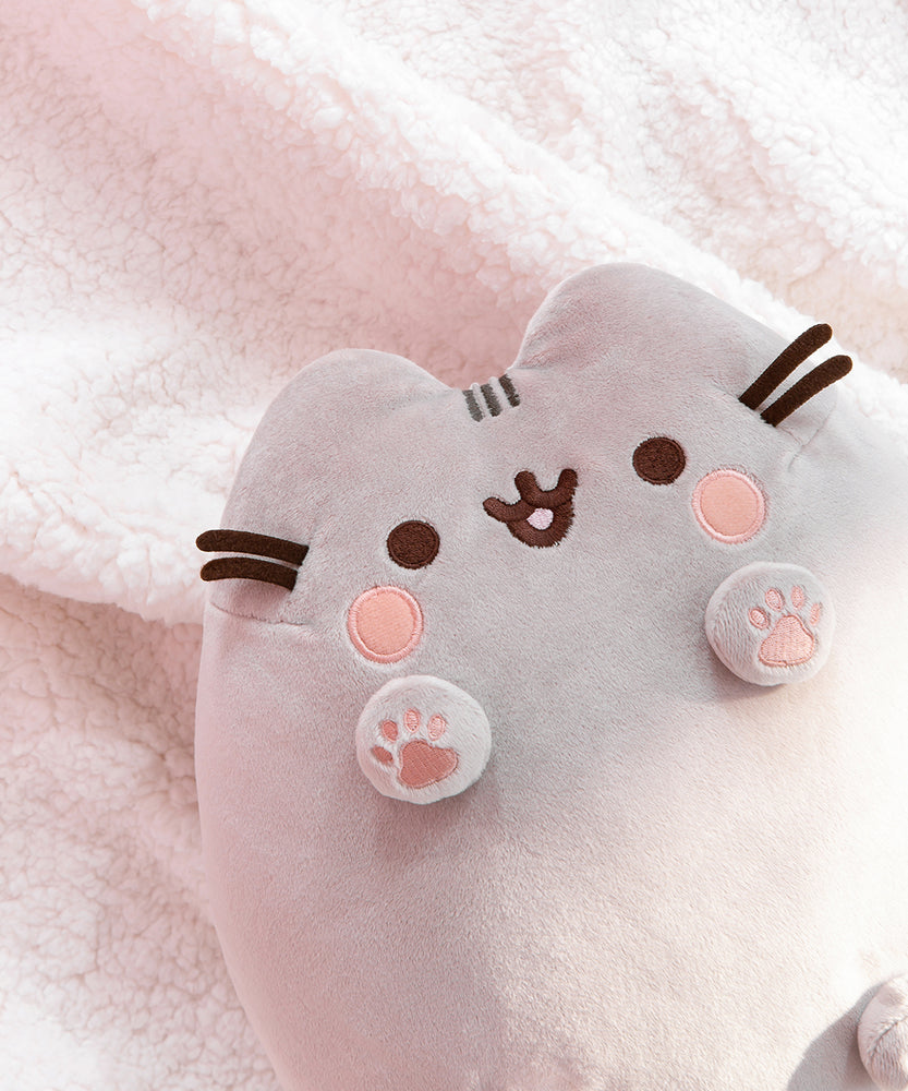 Back view of the plush shows Pusheen’s classic grey head and back stripes and striped grey tail.