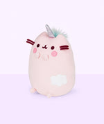 Quarter view of the Dreamy Pusheenicorn Squisheen facing the left in front of a light purple background. The white cloud on the front is more visible from this angle, though the multicolor mane is only visible directly behind Dreamy Pusheenicorn’s horn.