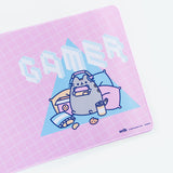 Angled close up of the Gaming Pusheen design on the Gaming Desk Mat. The isometric pixel text in the graphic have lines that indicate the font is made up of cubes.