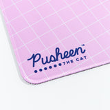 Close up of the Pusheen the Cat Logo on the lower left side of the Gaming Desk Mat. The edges of the mat are sewn, and the rubber base is partially visible.