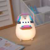Front view of the gaming lamp lit up. The grey cat body emits a light-yellow hue when turned on.  