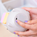 Model indicating the on/off switch of the Pusheen Gaming Lamp. The lamp can be powered via USB-C cord or with batteries.  