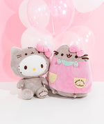 The Hello Kitty and Pusheen collaboration plush sit next to one another in front of a pink background and white and clear balloons.