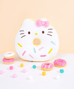 Full front view of Hello Kitty side of reversible Donut Plush. Donut plush lays on light white carpet surface.  