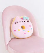 Pusheen side of the reversible Donut Plush. Pusheen’s stripes have turned pink, but she keeps her classic black eyes, nose, and whiskers while taking the form of a strawberry glazed donut. 