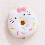 Full front view of Hello Kitty side of reversible Donut Plush. Donut plush lays on light white carpet surface.  