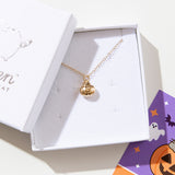 Close up of the gold charm necklace in the jewelry box