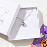 Close up of the silver charm necklace in the jewelry box